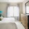 Bedroom with bright light from tall windows