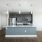Model kitchen area with island and lit by large windows in living area