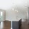Living area by kitchen with large windows and door to patio
