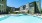 pool with lounge chairs and private cabanas