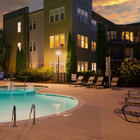 Swimming Pool pool with lounge chairs at dusk