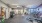 Open fitness center brightly lit by ceiling lights and windows